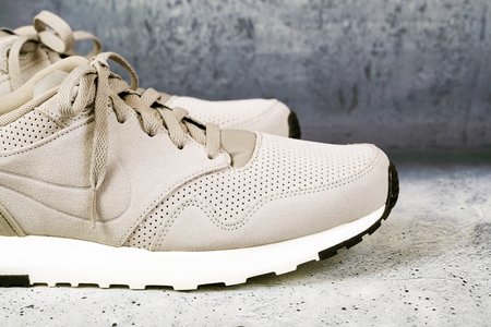 Pair of men's sports shoes on a concrete backgroundの写真素材