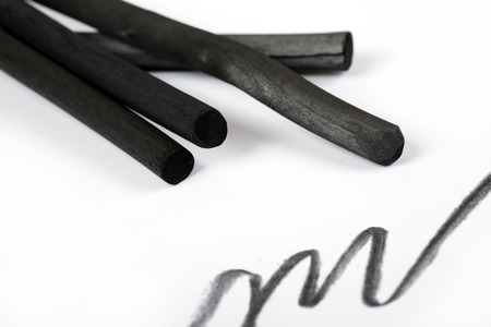 Charcoal artwork equipment on a white paperの写真素材