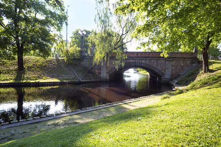 Stone Bridge through the small river in the park, Riga, Latvia.の写真素材