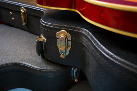 Red acoustic guitar close up in dark backgroundの写真素材