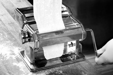 Process of production of fresh pasta.Doughfrom paste machine.Macro shotの写真素材