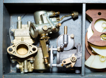 Different new boat carburators parts in wooden box.