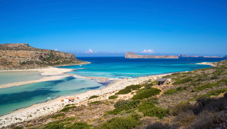 Balos lagoon on Crete island, Greece. Tourists relax in crystal clear water of Balos beach.