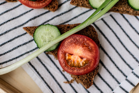 Healthy sandwich with rye bread, cucumber, tomato and green onionの写真素材