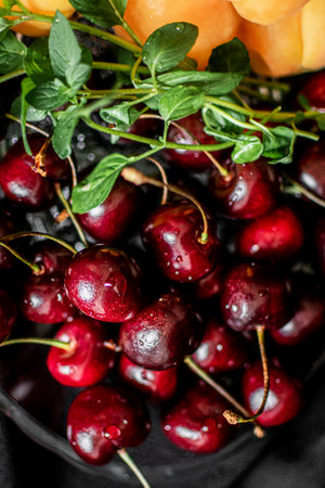 Cherriescots and apricots on black backgroundの写真素材