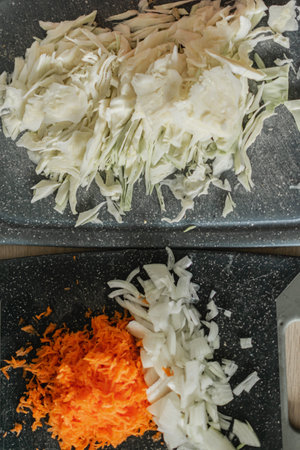 Sliced cabbage and carrots on a cutting board, top viewの写真素材