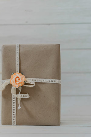 Gift box on white wooden background with copy space. Vintage tone.