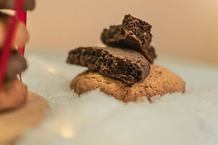 Chocolate chip cookies on white snow background. Selective focus.