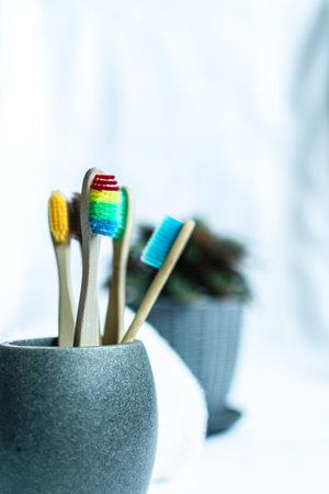 Toothbrushes in a ceramic vase on a white backgroundの写真素材