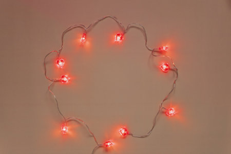 Christmas lights on the wall with space for your text or image. heart shaped card for valentine's day. light background. space for textの写真素材