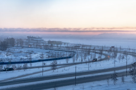 Winter landscape with road and houses in the fog at sunset. Russiaの写真素材