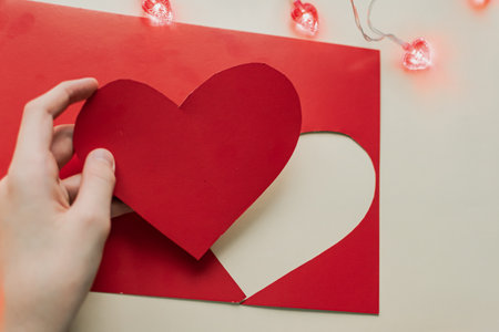 Valentine's Day card with red heart on white background.の写真素材