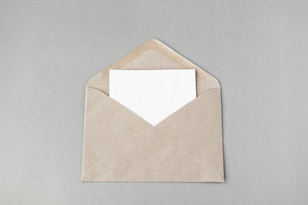 Envelope with blank paper sheet on grey background, top viewの写真素材