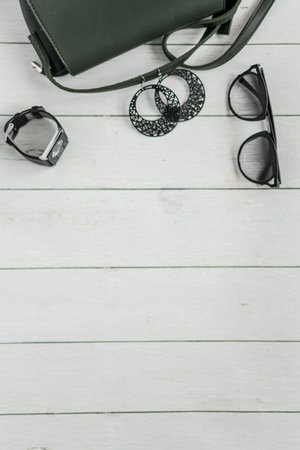 Women's accessories on a white wooden background. Flat lay, top view.の写真素材