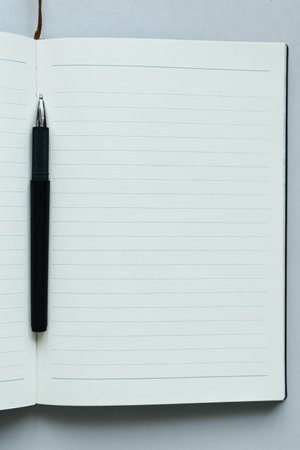 Pen and notebook on white background with copy space for add text.の写真素材
