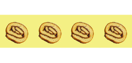 Biscuit roll slices isolated on yellow background, with fruit jam. Patern. Homemade baking.