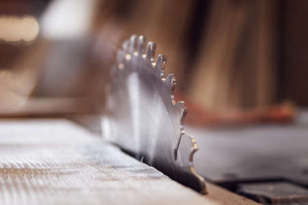 Circular wheel close-up, in sunlight. old rustic carpenter's workshop.の写真素材