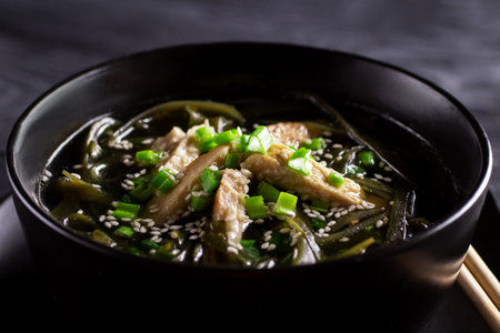 Korean food. Healthy meals for pregnant women. Seaweed soup with meat in a black bowl. birthday soup. tradition. custom. close-up.の写真素材