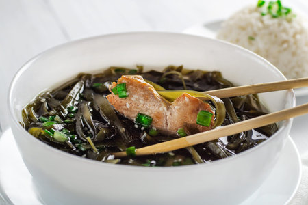 Korean seaweed soup with meat in white bowl and boiled rice. birthday soup. Traditional Korean Cuisine. healthy diet. Pregnancy. custom. close up.の写真素材