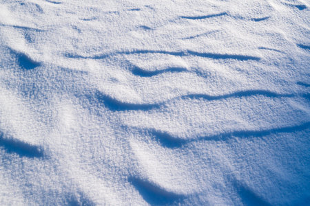 Patterns in the snow. Winter background. Snow texture. Natural backgrounds and textures.