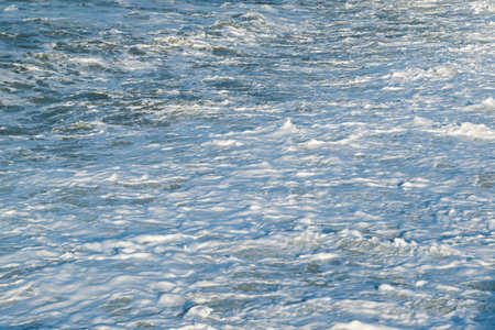 Sea foam on the beach. Sea coast. Marine natural background. Seascape.の写真素材