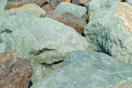 Lots of big stones. Stone background. Strengthening the coastline. Rocky seashore.