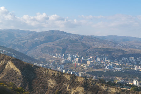 City view. Tbilisi, Georgia. Autumn city landscape. A city among the mountains. Blue sky.の写真素材