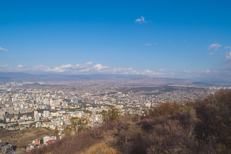City view. Tbilisi, Georgia. Autumn city landscape. A city among the mountains. Blue sky.