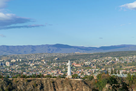 City view. View of Kartlis Deda. Tbilisi, Georgia. A city among the mountains. Sunset.の写真素材