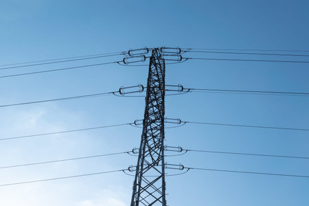 Power lines against a blue sky. Electricity and technology. Clear day.