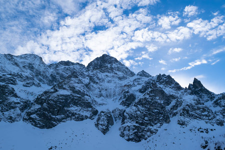 Snowy mountain peaks. Beautiful winter landscape in the mountains. Stone cliffs.