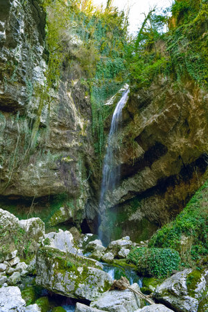 Waterfall in a gorge among the rocks. Beautiful natural landscape.の写真素材