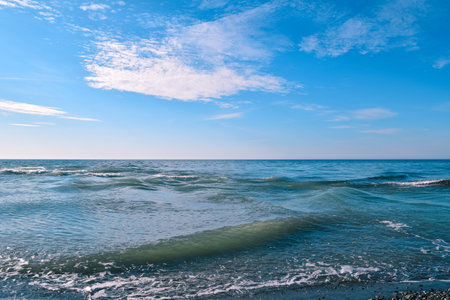 Blue sea, blue sky and white clouds. Simple seascape on a sunny day. Marine background.の写真素材