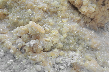 Close-up of greenish-yellow mineral crystals with a rough, textured surface