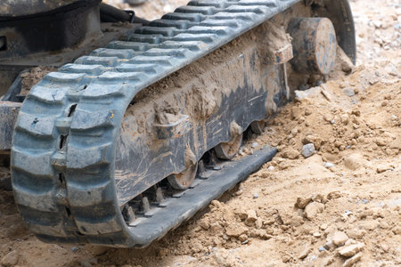Close-up of a crawler excavator in the ground. Construction equipment at a construction site.