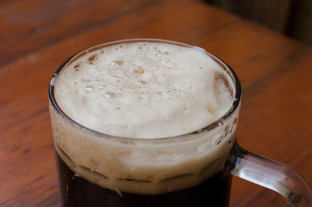 The mug of beer with foamの写真素材