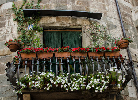 A balcony with flowers in Lucca Italyの写真素材