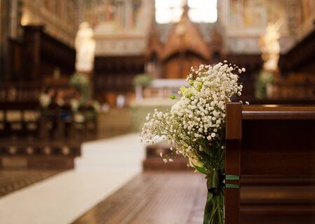 Wedding bouquet tied on the bench in Orvieto Cathedralの写真素材