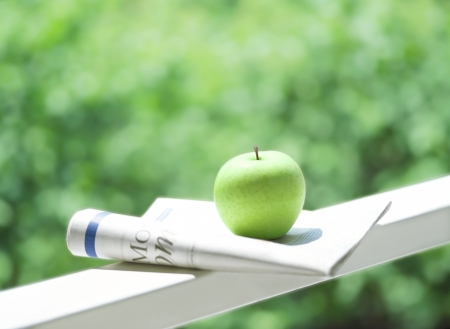 newspaper and appleの写真素材