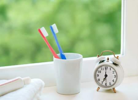 toothbrush and alarm clockの写真素材