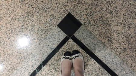 black and beige pair of ballerina on same colour backgroundの写真素材