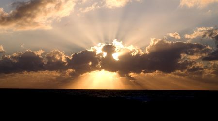 Cloud on a sunset with a crown of sharp beamsの写真素材