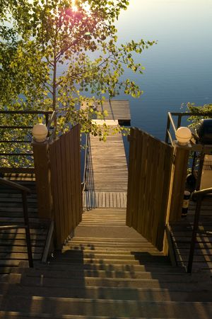 Open door of a ladder to lake, Finland, early evening in Julyの写真素材