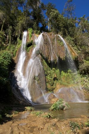 Waterfalls and rainbow under the stone in a province Trinidad, Cubaの写真素材