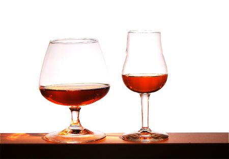 Two glasses with brandy on a white backgroundの写真素材
