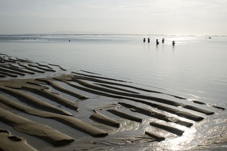 Fishermen on Indian ocean beach, outflow, morning, Indonesia Baliの写真素材