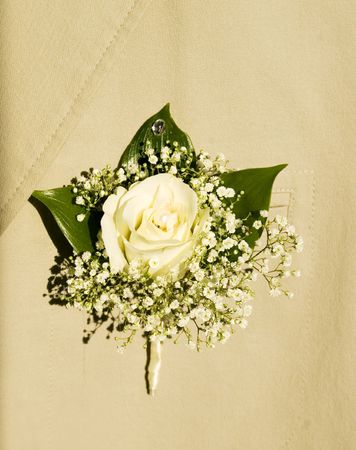 White bouquet in groom's buttonhole, white roses and pearlsの写真素材