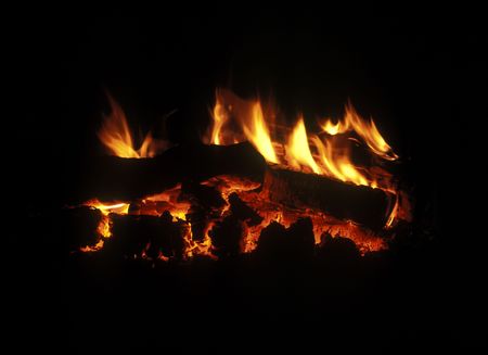 Burning down fire wood, fireplace, shine decayed coal in darknessの写真素材