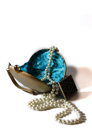 Lady's purse with pearls and mirror isolated on white backgroundの写真素材