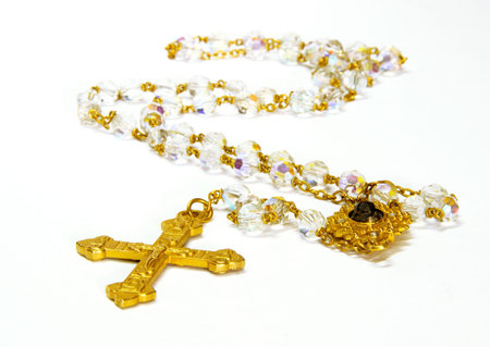 Crystal rosary and gold cross isolated on white backgroundの写真素材